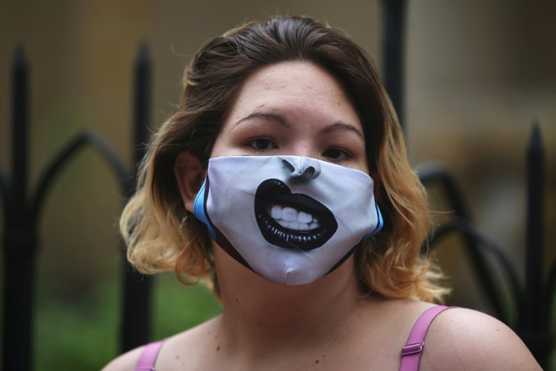 A Venezuelan migrant wearing a face mask is seen standing in line to receive food aid donated by officials from the Bogota embassy of Venezuelan opposition leader Juan Guaido,  who many nations have recognised as the country's rightful interim ruler, amid the coronavirus disease (COVID-19) outbreak in Bogota, Colombia May 29, 2020. REUTERS/Luisa Gonzalez